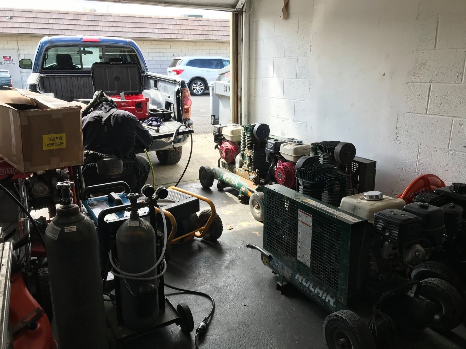Repair bay with compressors and gas-powered equipment