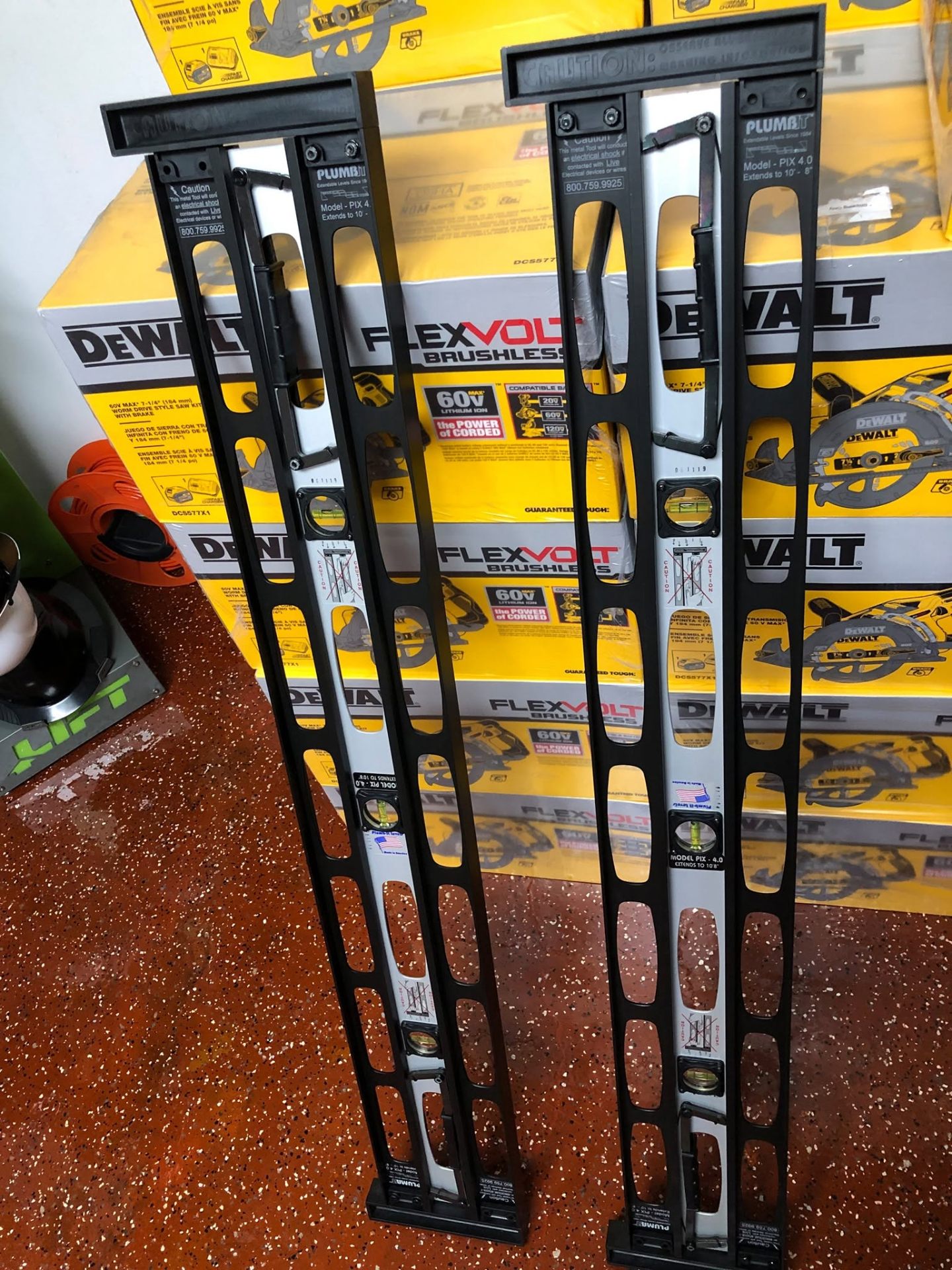 Plumb It extendable levels next to DeWalt FlexVolt saws